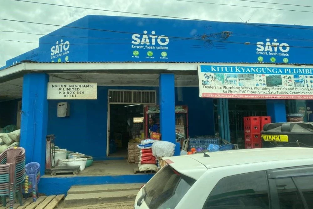 Kenyan merchant shop front, painted in blue, with the SATO logo in white.